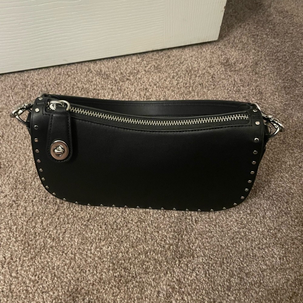 Coach swinger with rivets